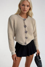 Soft Textured Beige Knit Cardigan with Floral Accessories